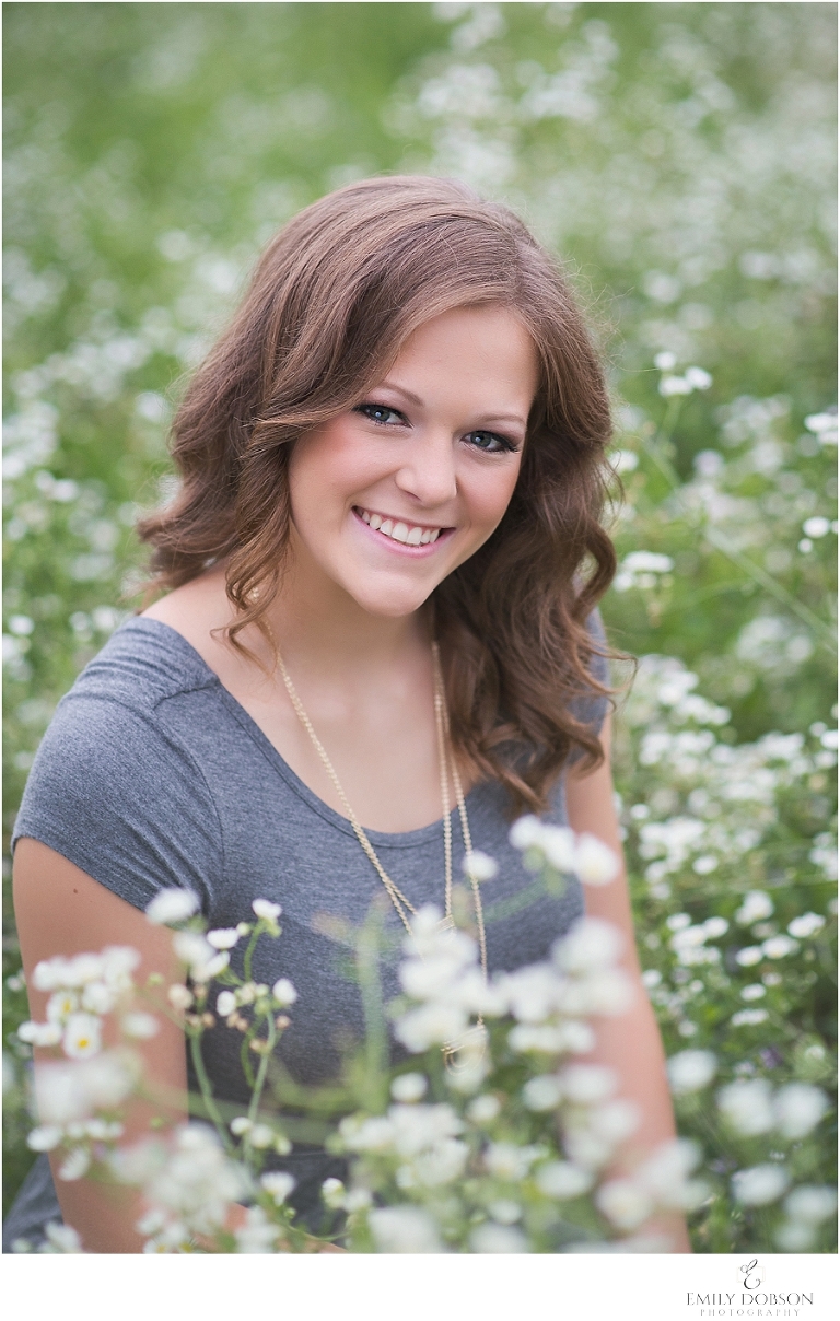 HS senior in a field of white wildflowers