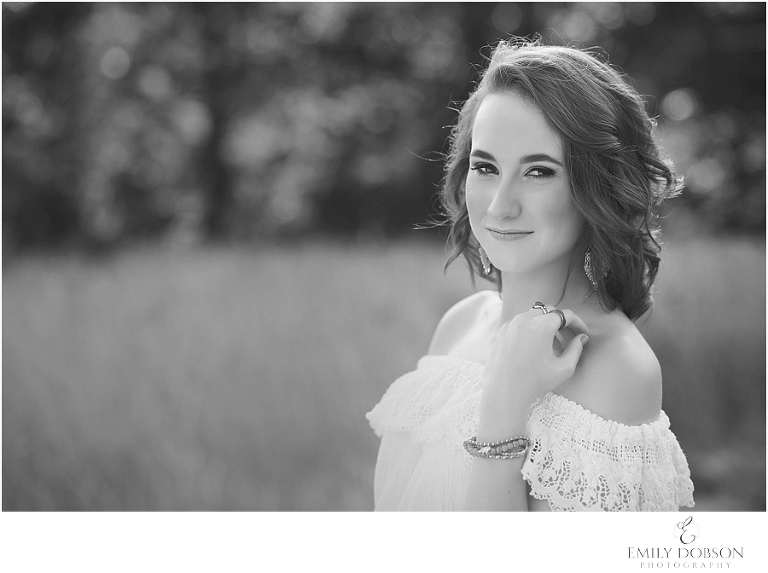 HS senior posing in a field of weeds