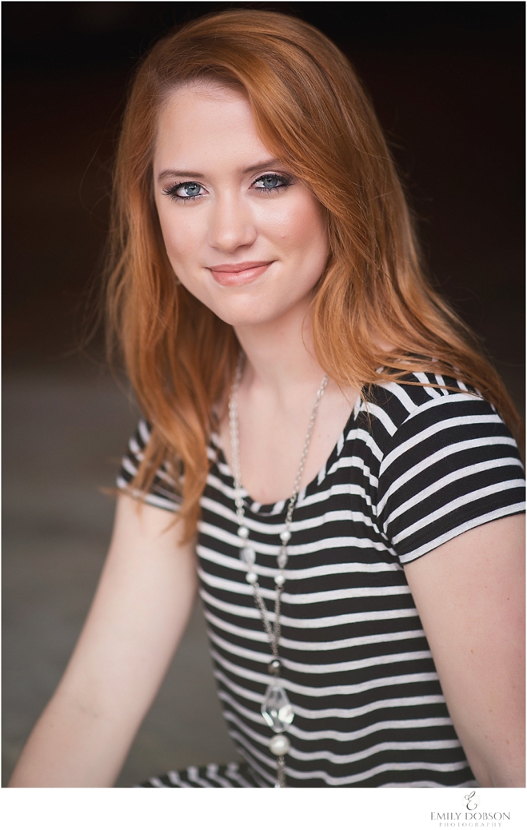 red head HS senior posing in a parking garage