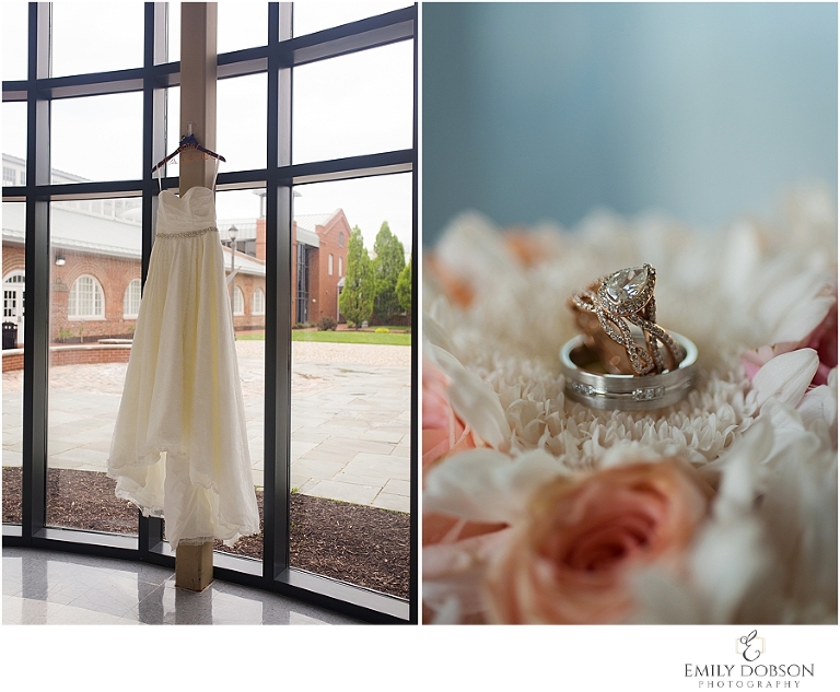 Bride's dress hanging from window; wedding rings in the flowers