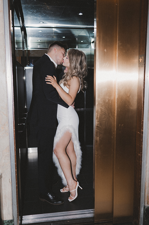 Couple kissing in an elevator