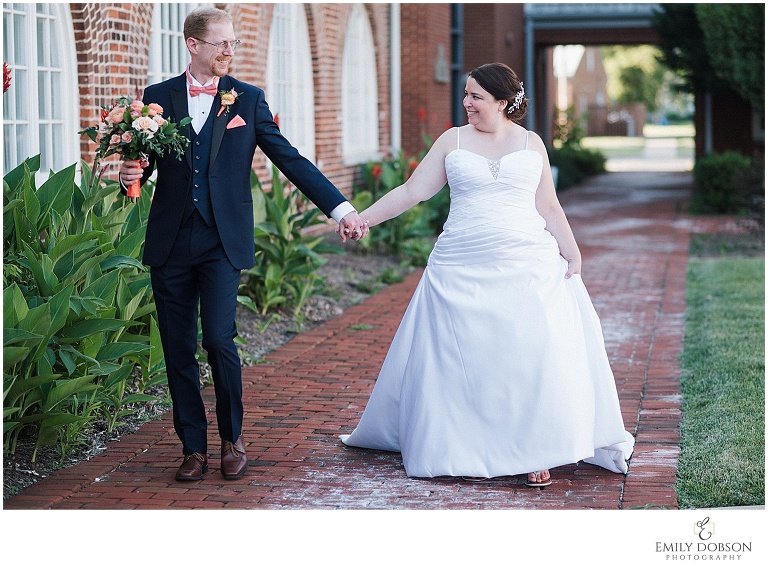 bride and groom walking and chuckling at one another